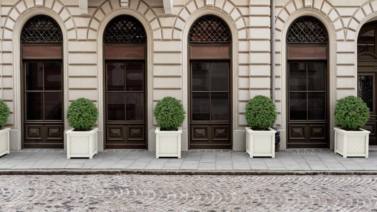 Exklusive pflanzkübel outdoor vor klassischer Fassade mit hohen Rundbogenfenstern